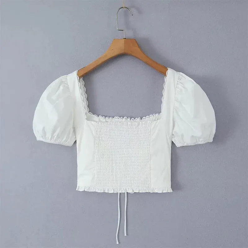 Modelo usando corset blanco de algodón con mangas bufantes – Veliara