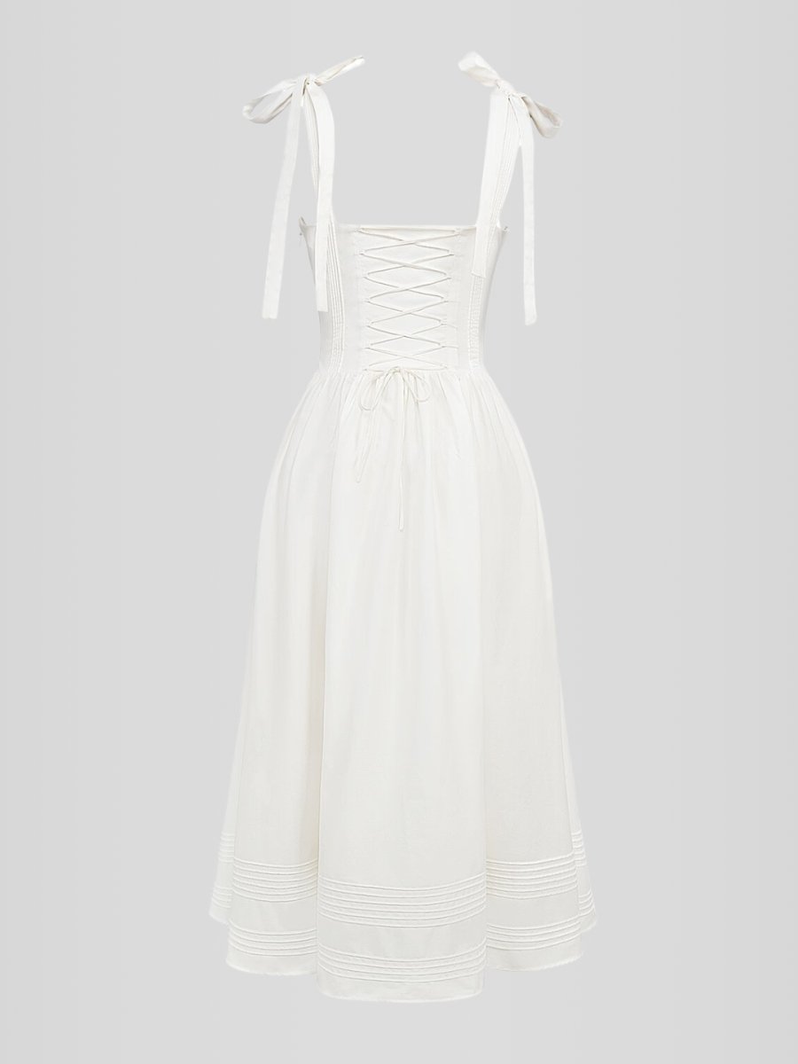 Vestido midi blanco sin mangas con corset estructurado y ballenas internas. Diseño elegante con bolsillos discretos y ajuste entallado.
